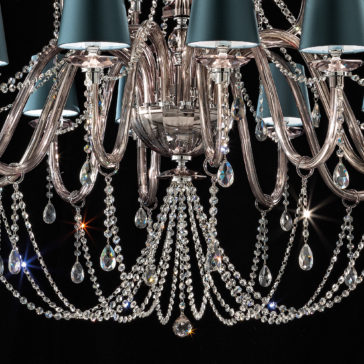 Large Modern Smoked Glass Chandelier With Shades A close-up shot of the Large Modern Smoked Glass Chandelier With Shades, showcasing its intricate metalwork and adorned with multiple crystal droplets. The cascading crystals reflect light brilliantly, while the metallic-finished lampshades enhance its luxurious appearance.