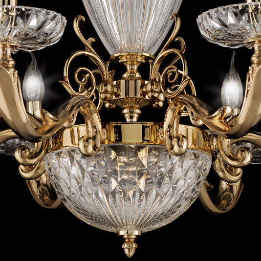 A close-up of the Luxury Faceted Blown Glass Chandelier showcases its golden metalwork and intricate faceted glass elements. The chandelier features multiple arms holding candle-like light bulbs, with a central glass bowl and elegant curved details set against a black background.