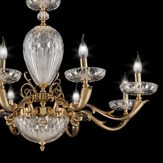 Introducing the Luxury Faceted Blown Glass Chandelier: an exquisite piece adorned with faceted blown glass and elegant gold accents. This luxurious chandelier features six candle-like light bulbs, a central crystal piece with intricate designs, and gold embellishments set against a sleek black background.