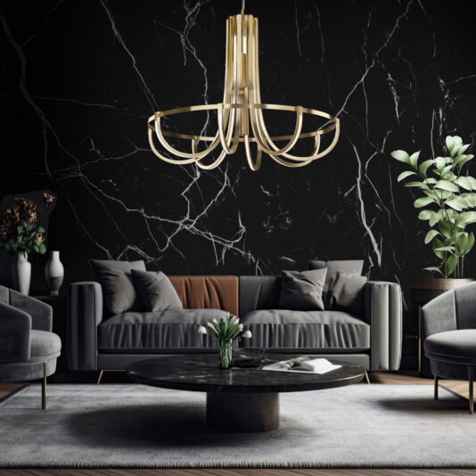 A modern living room features the Modern Sculptural Chandelier in a gold finish, a grey sofa, and matching armchairs. The decor includes a black marble wall, a round black marble coffee table, and green potted plants, creating a sophisticated and elegant atmosphere.