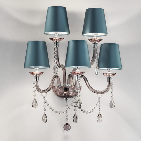 The Modern Smoked Glass Wall Light With Shades features five light blue lamp shades and sleek glass orbs suspended from transparent, curved arms. Elegant crystal pendants drape between the arms, infusing a touch of sophistication and sparkle to the fixture against a plain white background.