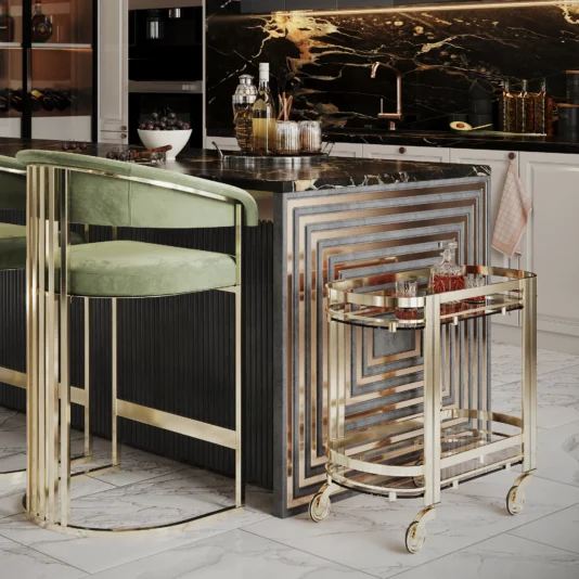 A luxurious kitchen with a marble island showcasing a geometric design is enhanced by modern velvet bar stools in rich green with gold frames. Nearby, a Contemporary Curved Drinks Trolley holds drinks, against dark cabinets and a black and gold marble backsplash.