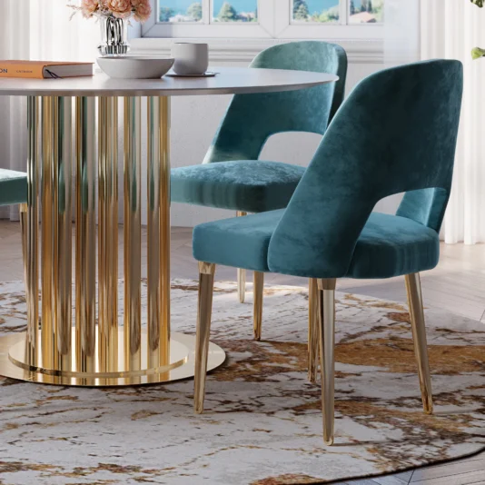 Contemporary Teal Dining Chair A modern dining room features a round table with a gold base and two Contemporary Teal Dining Chairs. The floor boasts a textured rug, while pink flowers and white cups adorn the table by a bright window.