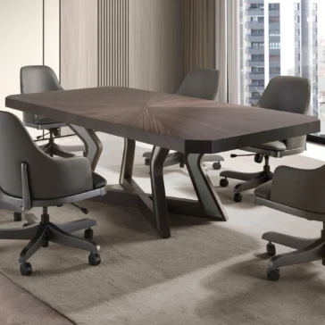 Luxury Veneered Boardroom Table A modern conference room showcases the Luxury Veneered Boardroom Table with a geometric design, surrounded by six gray swivel chairs. The light-colored carpet and large windows offer a stunning cityscape view.