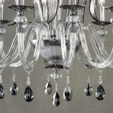 A close-up of the Modern Chandelier With Swarovski® Crystals reveals intricately curved glass arms, multiple bulb bases, and sparkling crystal accents that reflect light to create a sophisticated and luxurious ambiance.