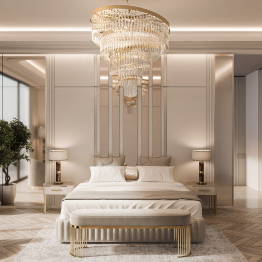 A luxurious bedroom features a sizable chandelier and a bed with white linens. The Contemporary Art Deco Style Bench complements mirrored nightstands and modern lamps, while neutral tones, contemporary accents, and a potted plant add elegance to the decor.