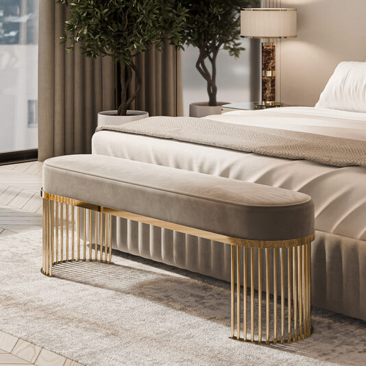 Luxurious bedroom with a plush bed and a Contemporary Art Deco Style Bench in beige, featuring golden legs at the foot. A large window, tall plant, table lamp, and warm-toned curtains add to the elegant and cozy atmosphere.