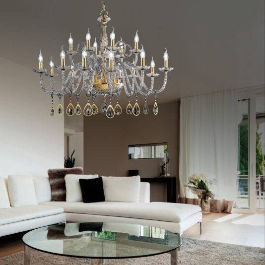 Elegant living room with the Large Glass Chandelier With Swarovski® Crystals And Pearls hanging from the ceiling. The room features a white sectional sofa with dark pillows, a round glass coffee table, a cabinet with a mirror above it, and large windows covered with white curtains that allow natural light in.