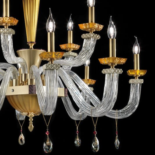 The Elegant Amber Glass Chandelier features multiple candle-like lights and intricate gold details, set off by elegant amber glass, clear elements, and decorative dangling crystals against a black background.
