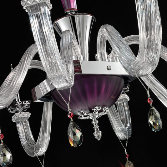 Close-up of the Elegant Large Amethyst Glass Chandelier showcasing its clear, curved glass arms and amethyst accents. The chandelier is adorned with red and clear teardrop-shaped crystal pendants, all set against a black background. Its metallic central structure is polished and reflective.