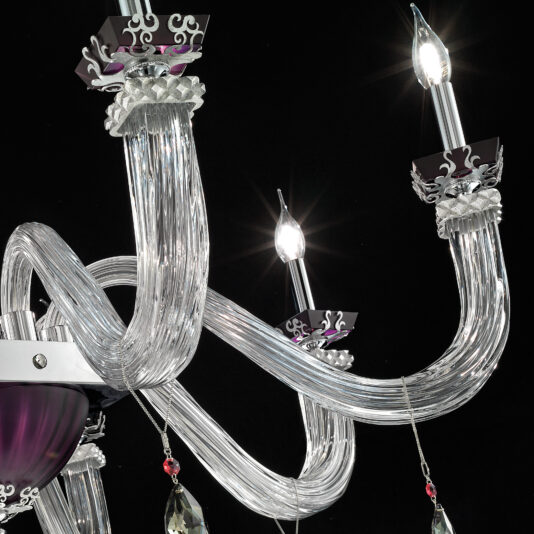 Close-up of the Elegant Large Amethyst Glass Chandelier, showcasing its ornate design with curved arms and lit candle-like bulbs. The chandelier features decorative metallic and crystal accents, hanging pendants, and intricate patterns. Against a black background, the exquisite details of this stunning piece are highlighted beautifully.