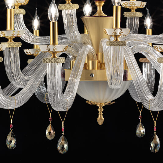 The Large Elegant Chandelier with Pendant Drops, showcasing twisted glass arms and candle-like light fixtures, hangs gracefully against a black backdrop. Its gold and glass elements, combined with dangling crystal ornaments, impart an opulent touch to its design.
