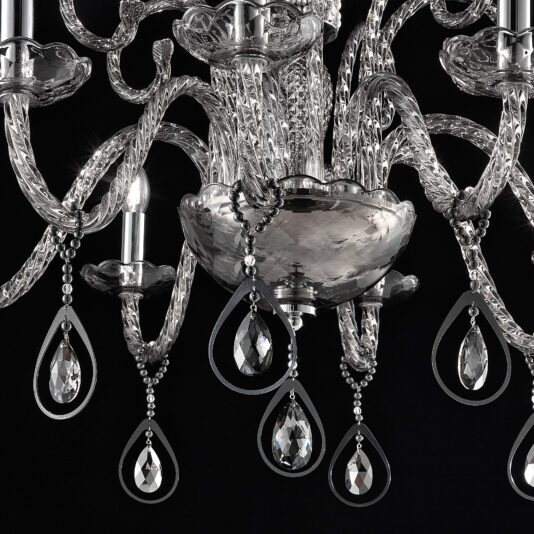 A close-up of the Smoked Glass Chandelier With Pendant Drops set against a black background. The chandelier showcases intricately twisted glass arms and several teardrop-shaped pendant drops, sparkling as they catch the light.