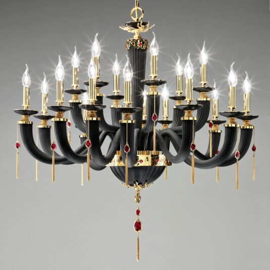 The Classic Black Chandelier With Swarovski® Crystals features 24 candle-shaped lights, curving arms, gold accents, intricate detailing, and red gemstone decorations for an elegant and opulent appearance.