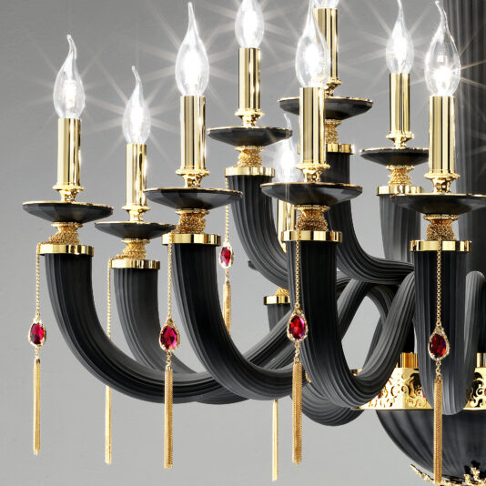 The Classic Black Chandelier With Swarovski® Crystals exudes luxury, showcasing curved arms embellished with gold details and hanging red gemstone ornaments. Each arm is designed to hold a candle-shaped light bulb, offering an elegant and opulent look against a gray backdrop.