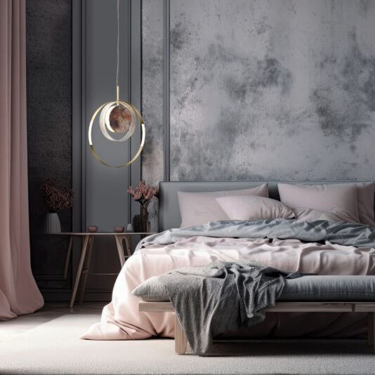 A stylish bedroom showcases a minimalist bed adorned with light grey and pink bedding, enhanced by the sophisticated glow of the Contemporary Round Pendant Light With Marble Effect hanging above. The backdrop features a textured grey wall, accompanied by a small bedside table decorated with elegant touches, including delicate pink flowers.