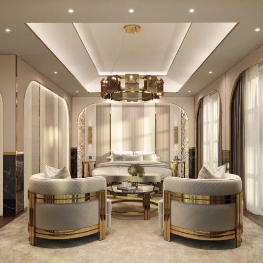Contemporary Round Smoked Glass Coffee Table A luxurious bedroom with elegant décor features a large, centrally placed bed adorned with a gold-framed headboard. The room boasts two plush armchairs and the Contemporary Round Smoked Glass Coffee Table, complemented by lavish light fixtures. Gold accents and soft neutral tones enhance the walls, ceiling, and floor.