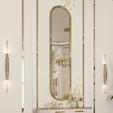 Large Lozenge Modern Wall Mirror A luxurious interior showcases the Large Lozenge Modern Wall Mirror framed in gold, set against a patterned wall with gold accents. Two sleek wall-mounted light fixtures are positioned on each side of the mirror. Below, a countertop displays a bouquet of white flowers and various decorative bottles, while ceiling lights reflect beautifully in the mirror.