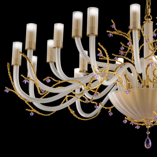 The Large Modern Chandelier With Swarovski Crystal Flowers is an elegant piece, showcasing white curved arms with gold accents and adorned with small purple decorative elements. Featuring multiple candle-like lights, its intricate design details add a luxurious feel against the dark background.