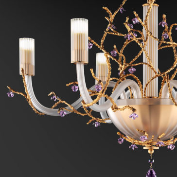 Modern Chandelier With Swarovski Crystal Flowers A close-up photo of the **Modern Chandelier With Swarovski Crystal Flowers** showcases its elegant, modern design. The chandelier features gold branches adorned with small purple Swarovski crystal flowers, and multiple candle-like lights with frosted glass covers extend from a central golden base. The background is a dark gray.