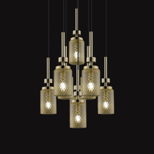 The Pendant Light Cluster With Balloton Effect Glass Shades showcases seven cylindrical shades arranged in two tiers, each adorned with a textured Balloton pattern. Suspended by black cords and complemented with gold fixtures, the shades form an elegant display against a solid black backdrop.