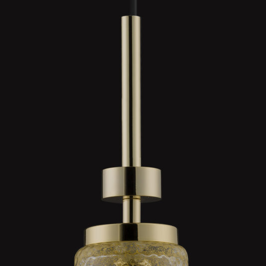 A close-up of the Pendant Light With Balloton Effect Glass Shade, featuring a sleek, gold-colored metallic rod and cylindrical components. The light's Balloton effect glass shade is accentuated against a dark background, highlighting its shiny surface and contemporary design.