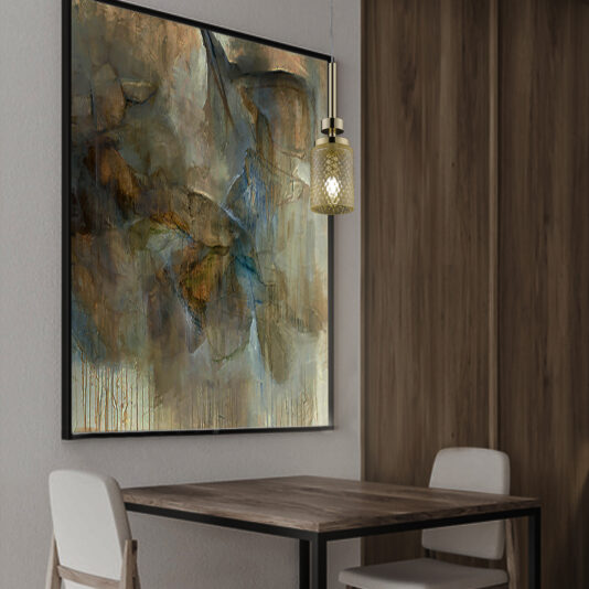A cozy dining area featuring a small wooden table with two white chairs. A modern Pendant Light With Balloton Effect Glass Shade hangs above the table, casting a warm glow. On the wall is a large, abstract painting with earthy tones of brown, blue, and green.
