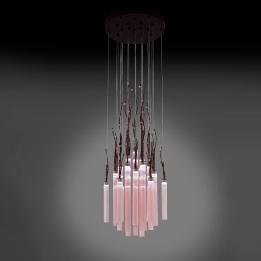 The Pink Fluted Glass Chandelier With Swarovski Crystal Flowers hangs from the ceiling, showcasing a contemporary design with its cluster of pink fluted glass tubes suspended from delicate wires. Dark, branching accents intermingle with Swarovski crystal flowers and the glass pieces, adding an organic touch to this modern fixture.