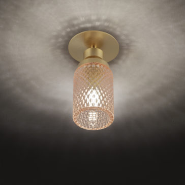 The Spotlight With Balloton Effect Glass Shade is a gold-toned, ceiling-mounted fixture that emits a warm glow, creating a patterned reflection on the ceiling. The light blends modern and elegant design with its intricate detailing and metallic finish.