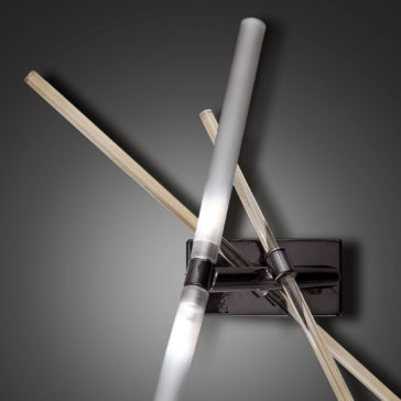 Contemporary Murano Glass Tube Wall Light The Contemporary Murano Glass Tube Wall Light showcases three LED tubes in various orientations, all connected to a sleek, rectangular black base. The design is reminiscent of Murano glass and is complemented by a gradient gray backdrop that enhances its minimalist aesthetic.
