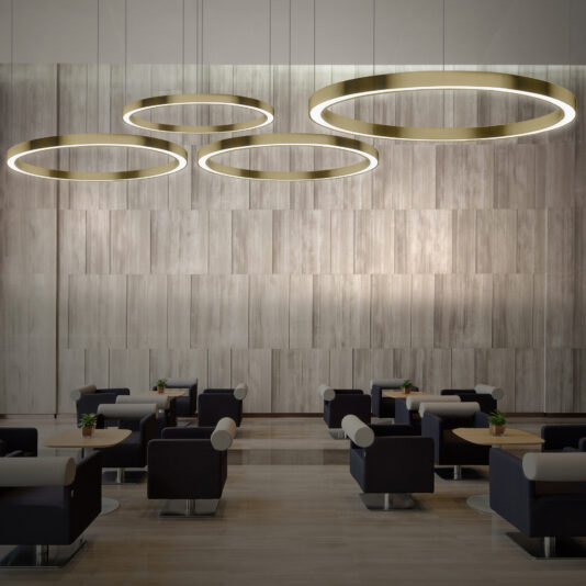 A modern, minimalist lounge featuring black chairs with white cushions arranged in pairs around small tables. Four *Contemporary Round Downlight Chandeliers* hang from the ceiling, casting a warm glow. The backdrop is a textured wooden wall, adding an elegant touch to the space.