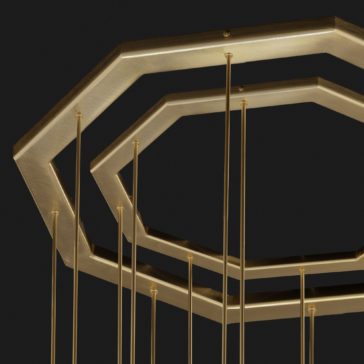 Large Modern Geometric Pendant Style Chandelier A close-up image of the Large Modern Geometric Pendant Style Chandelier features golden, octagonal frames connected by vertical, slender rods and suspended from a ceiling against a neutral, dark background. The layered frames create a captivating geometric pattern.