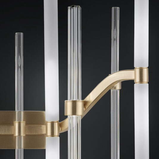 Large Vertical Murano Glass Tube Wall Light A close-up of the Large Vertical Murano Glass Tube Wall Light reveals a stunning modern chandelier with frosted and clear glass rods, supported by sleek, gold-finished metal brackets against a dark background. The design masterfully blends linear elements with elegant metallic accents, reminiscent of its namesake’s sophisticated aesthetic.