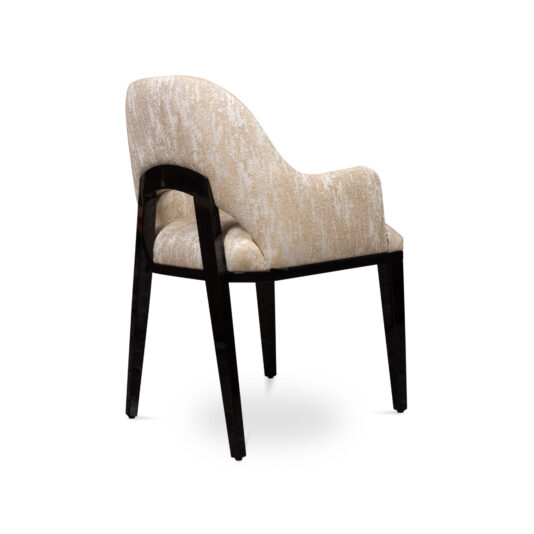 A modern, plush armchair with white and beige patterned fabric upholstery pairs elegantly with the Luxury Round Ebony Veneer Dining Table Set. The chair, showcasing a curved, cushioned backrest and wooden legs, seamlessly blends comfort with contemporary style.