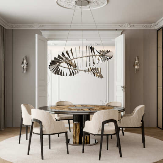 A modern dining room featuring the Luxury Round Ebony Veneer Dining Table Set, complete with a circular glass top adorned with wooden inlays, surrounded by five cream-colored upholstered chairs. Above the table hangs an abstract metallic chandelier. The room is accented with ornate double doors, intricate ceiling moldings, and decorative wall sconces.