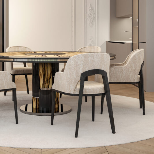 A modern Art Deco-style dining room showcases a round table with a patterned wooden top, held up by a glossy black cylindrical base. Surrounding the table are six **Modern Art Deco Style Tub Dining Chairs** upholstered in light fabric with dark wooden legs, all arranged on a neutral-colored round rug.