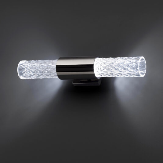The Modern Faceted Crystal Wall Light includes two cylindrical, textured glass shades flanking a central metallic mount. It casts a soft, white glow from both ends against a dark background.