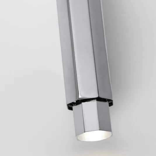 A close-up view of the Modern Geometric Tube Style Wall Light, showcasing its minimalist, hexagonal shape with a metallic, reflective finish. This ceiling fixture emits a soft, focused beam downward and is set against a plain white background.