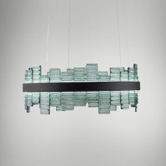 A Modern Round Venetian Glass Chandelier hangs from the ceiling. It features a central black band and multiple rectangular glass panels arranged around it, creating an artistic, geometric appearance. The light emitted is soft and diffused.