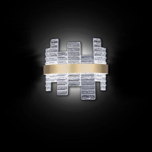 The Modern Venetian Glass Wall Light boasts a geometric design set against a sleek black background. Its stacked, translucent glass rectangles emit a soft white light and are elegantly accented by a horizontal metallic band at the center.