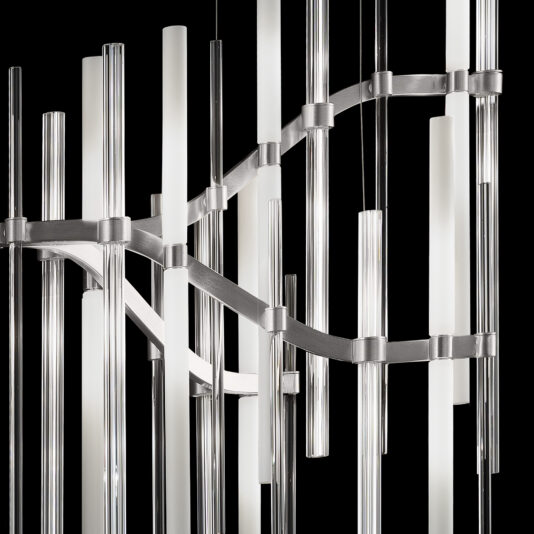 The Vertical Murano Glass Tube Chandelier features a sophisticated design with vertical glass tubes of varying lengths, interconnected by metallic horizontal bands in a wave-like pattern. The clear tubes include frosted sections and are intricately arranged against a black background, creating a sleek and modern aesthetic.