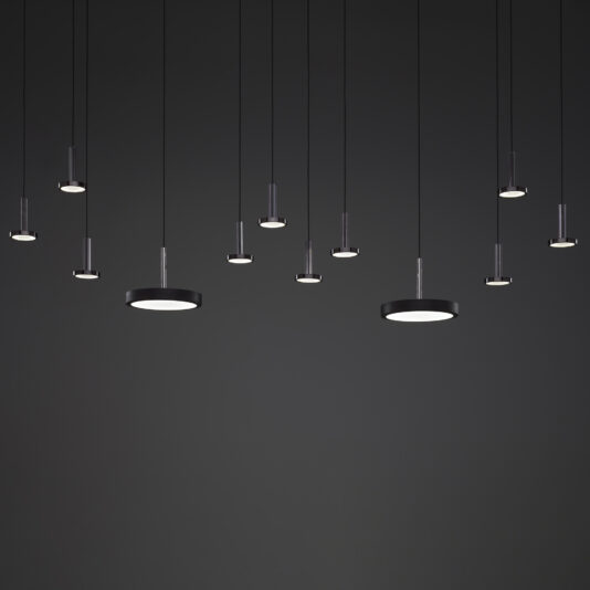 Contemporary Round Pendant Light A series of Contemporary Round Pendant Lights in varying sizes hang from the ceiling against a dark background. The lights feature a sleek, circular design and emit a soft, white glow, adding a minimalist touch to the space.