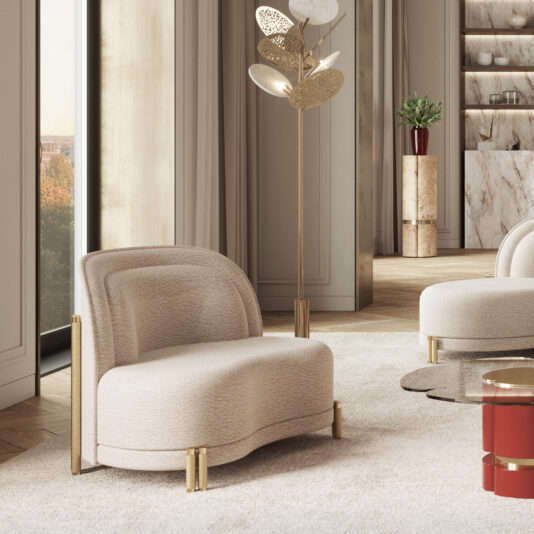 A stylish, modern living room featuring the Contemporary Curved Velvet Armchair with gold accents, a floor lamp adorned with a metallic leaf design, and a round glass coffee table. The room also includes large windows, neutral-colored walls, and shelves displaying decor items.