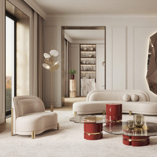 A modern living room features a large window, neutral-toned furniture, and red-accented decor. The space includes a cream-colored sofa and chair, round coffee tables with red bases, and a tall brass floor lamp with white shades. Elegance is added near the doorway to an adjoining room by the Contemporary Curved Velvet Armchair.