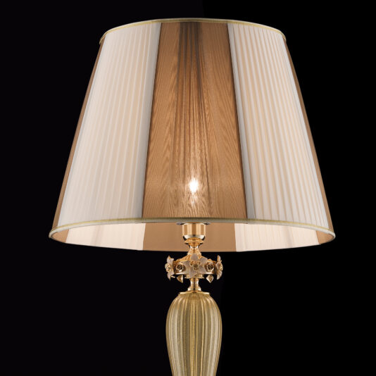 Hand Blown Glass Floor Lamp With Flowers A close-up of an elegant table lamp with a golden, textured base and a pleated, two-tone lampshade. The creamy white and brown vertical panels glow softly from the center against a black background, reminiscent of the intricate detailing found in the Hand Blown Glass Floor Lamp With Flowers.