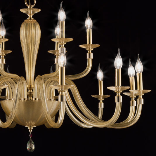 Hand Blown Gold Sheen Glass Chandelier The Hand Blown Gold Sheen Glass Chandelier is a stunning piece with an elegant design featuring ten curved arms, each holding a lit lamp resembling a candle. It boasts a central bulbous structure and is adorned with a single hanging crystal ornament at the bottom, set against a dark background.
