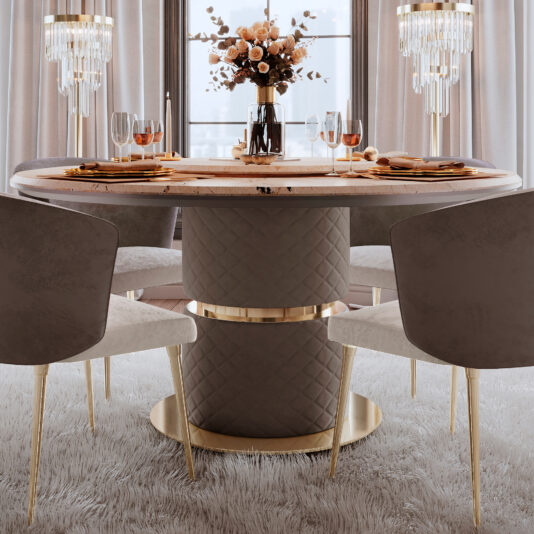 A sophisticated dining area showcases the Marble Round Dining Table with Lazy Susan, surrounded by four sleek, armless chairs with gold accents. The table is set elegantly with plates, silverware, wine glasses, and adorned with a floral centerpiece and chandeliers above.