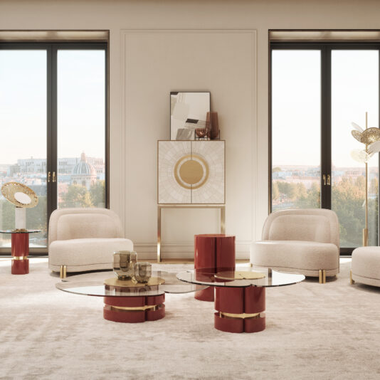 A bright living room with large glass doors showcasing a cityscape view. The space features the Modern Lacquered Coffee Table Set, which includes round glass tops and red bases, complemented by cream-colored armchairs. A unique cabinet with a circular design and a floor lamp shaped like leaves add decorative touches.