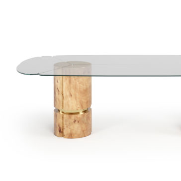 Modern Veneered Rectangular Glass Dining Table Introducing the Modern Veneered Rectangular Glass Dining Table: a sleek and contemporary piece featuring a unique design. It boasts a transparent glass top with rounded edges, elegantly supported by two cylindrical wooden columns, adding a natural and refined touch to any dining space.