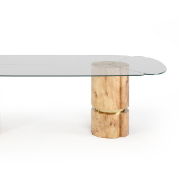 Modern Veneered Rectangular Glass Dining Table The Modern Veneered Rectangular Glass Dining Table boasts a sleek, minimalist design featuring a clear glass top and wooden cylindrical legs. The warm, natural wood supports are accentuated with gold bands at the center of the legs, creating a contemporary and elegant look.